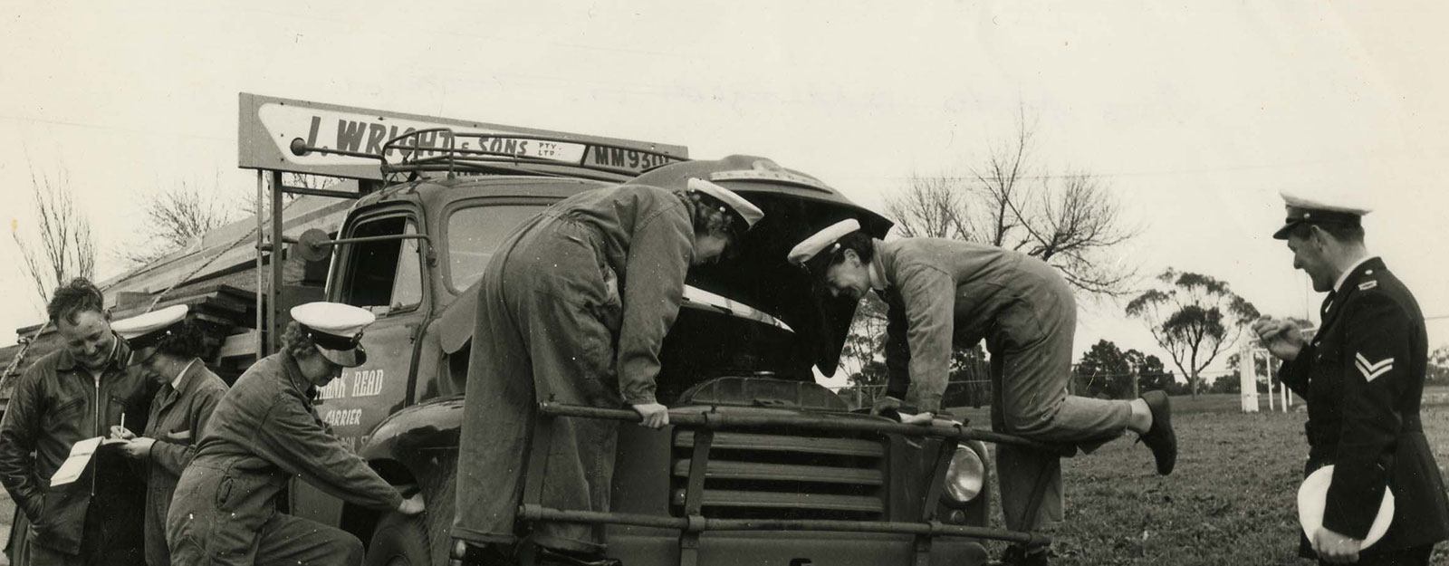 Photo of policewomen cadets inspecting truck for roadworthiness 